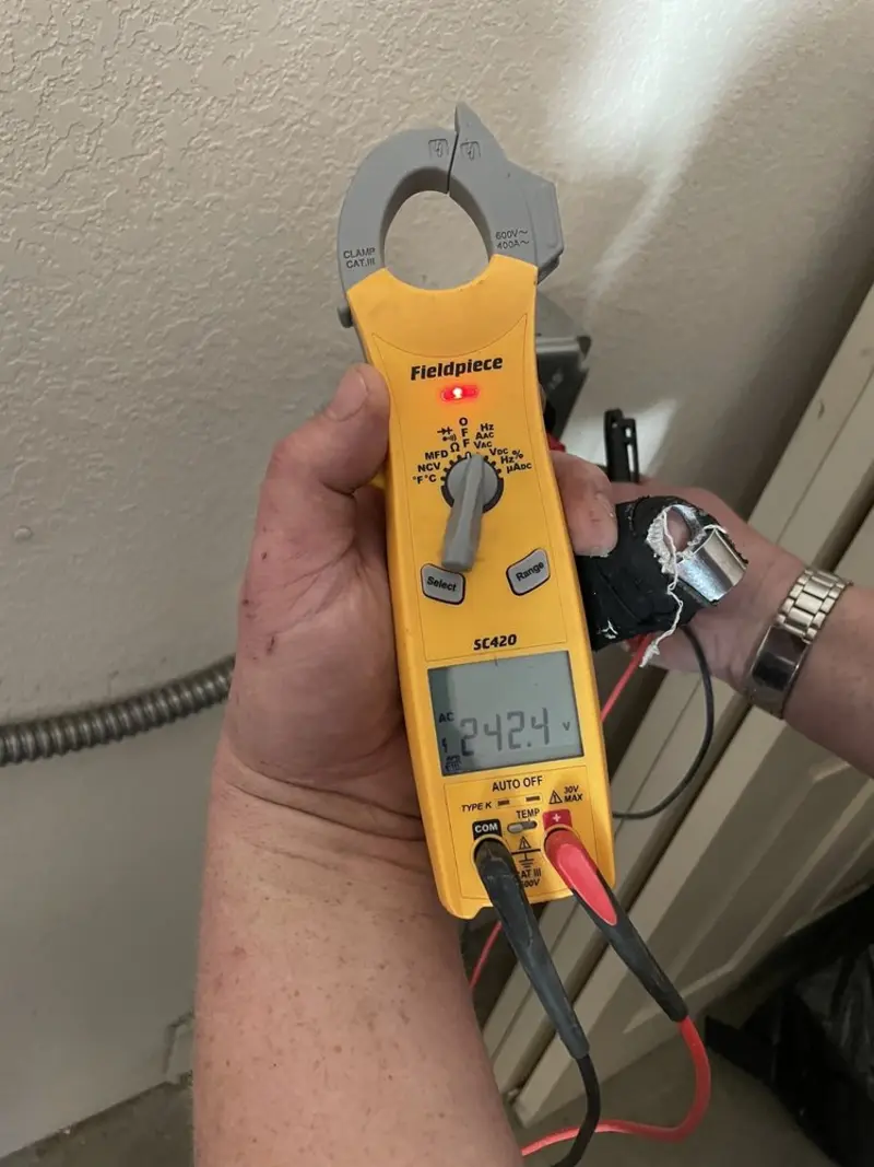 Voltage testing with clamp meter during Outlet Installation in Bella Vista